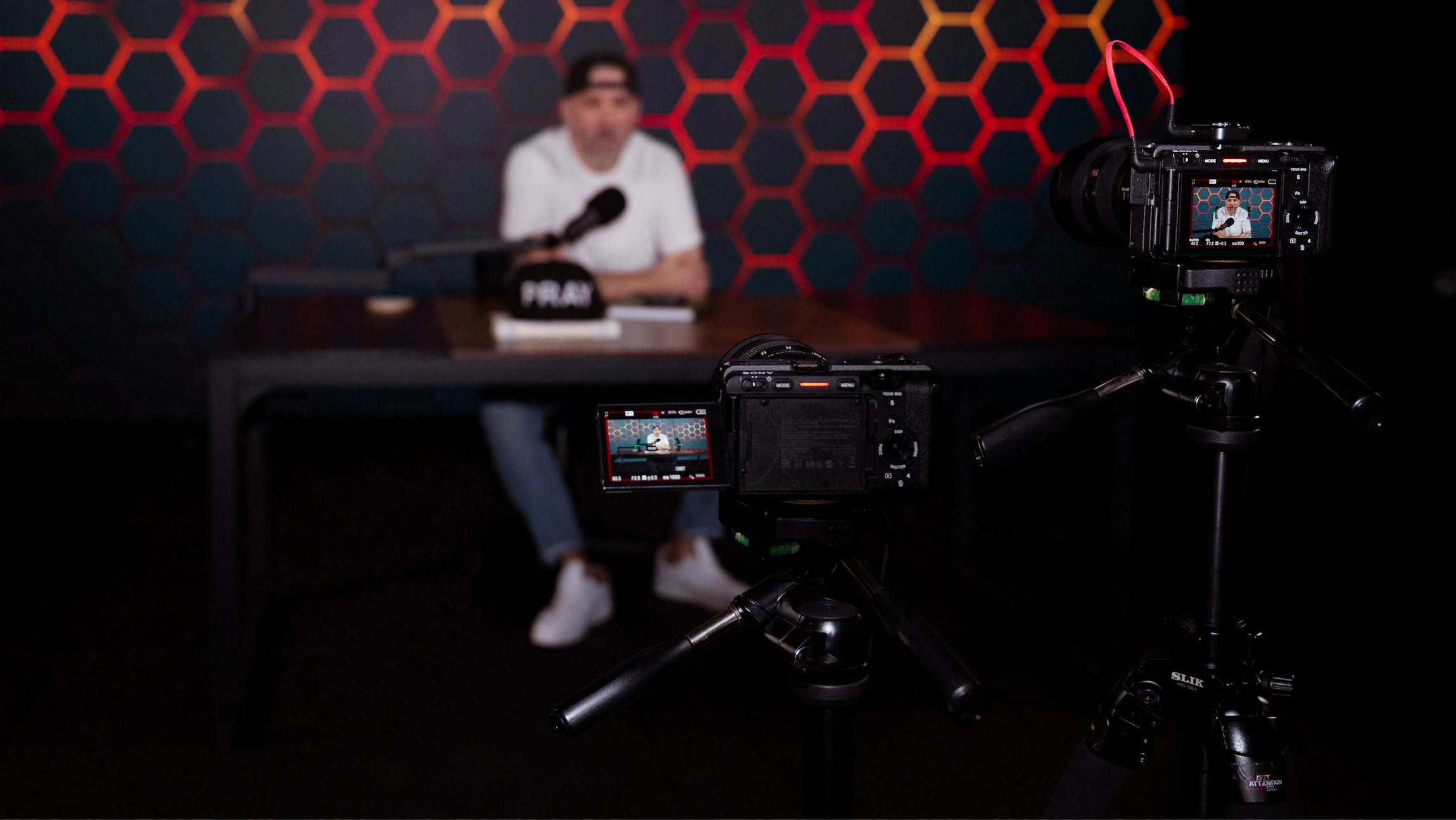 Cracked Egg Creative team during a professional video production shoot, with camera, lights and LED wall visible in the studio.